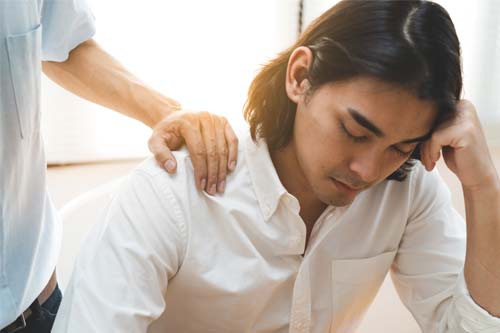 sad man getting comfort in behavioral health program