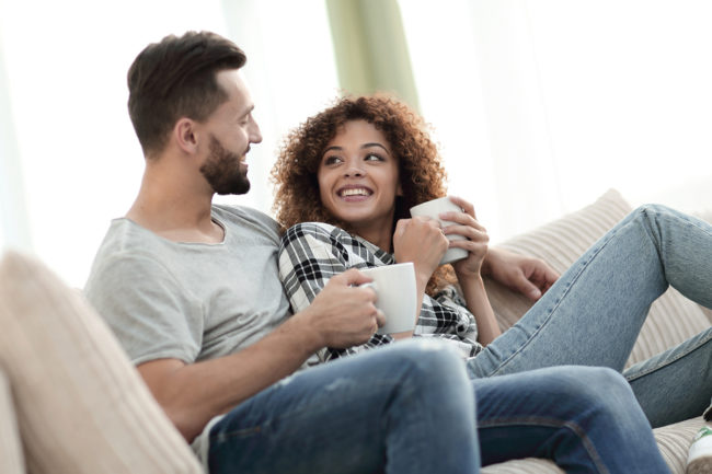 couple drinking coffee on couch knowing the importance of drug detox